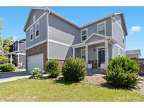 Charming two-story home with a well-manicured lawn and a welcoming front porch at 13644 Ulster St, Thornton, CO 80602