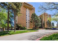 Attractive brick condominium building with landscaped grounds and mature trees at 8060 E Girard Ave # 712, Denver, CO 80231