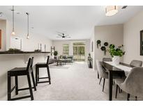 Bright dining area with a modern table and four gray chairs at 13456 Via Varra # 118, Broomfield, CO 80020