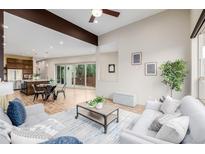 Bright open-concept living space with modern furnishings and light hardwood floors at 1848 W 68Th Ave, Denver, CO 80221
