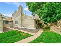 Exterior view of a charming home with siding and a well-kept lawn at 3890 S Atchison Way # B, Aurora, CO 80014