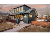 Charming home featuring a cozy front porch, landscaped yard, and a welcoming hot tub area at 4452 Stuart St, Denver, CO 80212