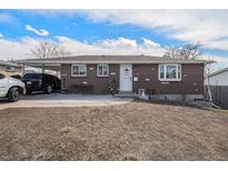 Charming brick home featuring a spacious carport and a well-manicured lawn on a sunny day at 2562 E 90Th Pl, Thornton, CO 80229