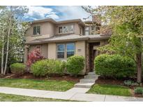 Attractive two-story home features a stone accent, landscaped front yard, and welcoming entrance at 9266 E 35Th Ave, Denver, CO 80238
