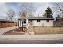 Charming single-story home featuring a well-maintained front yard and stone pathway at 5646 Jellison St, Arvada, CO 80002