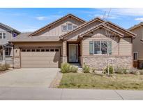 Charming single-Gathering home featuring a two-car garage and a stone-accented facade with beautiful landscaping at 13912 Ashgrove Cir, Parker, CO 80134