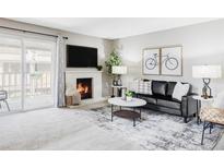 Inviting living room featuring a fireplace, modern decor, and a sliding glass door leading to outdoor space at 5300 E Cherry Creek South Dr # 620, Denver, CO 80246