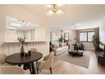 Bright living room with modern lighting, neutral tones, and open-concept design for easy entertaining at 10490 W Jewell Ave # D, Lakewood, CO 80232