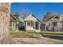 Charming craftsman bungalow with front porch and well-manicured lawn at 4418 Utica St, Denver, CO 80212