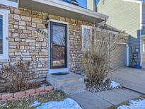 Inviting front door entrance with stone accents and landscaping at 8448 W Union Ave # 9, Littleton, CO 80123