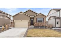 Charming single-Gathering home showcasing neutral siding, stone accents, two-car garage, and manicured front yard at 2326 Monte Vista St, Fort Lupton, CO 80621