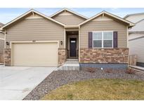 Lovely home with neutral siding, stone accents, well-maintained lawn, and attached two-car garage at 2326 Monte Vista St, Fort Lupton, CO 80621