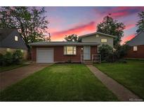 Charming brick home with a well-maintained lawn and landscaping at 1330 Quari St, Aurora, CO 80011