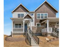 Charming two-story home with stone accents and a welcoming front porch and new landscaping at 22272 E 7Th Pl, Aurora, CO 80018