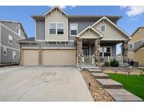 Charming two-story home with a three-car garage and stone-accented facade at 20888 E 51St Pl, Denver, CO 80249
