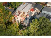 Stunning aerial view of custom home with multiple decks and mature trees surrounding the property at 2034 Newton St, Denver, CO 80211