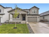 Charming two-story home with a welcoming front porch and well-maintained landscaping at 1420 E Witherspoon Dr, Elizabeth, CO 80107