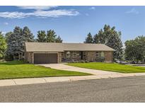 Brick ranch house with attached garage and landscaped lawn at 13627 W Alaska Dr, Lakewood, CO 80228