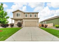 Charming two-story home with landscaped front yard, long driveway, and attached two-car garage at 7218 Animas Ave, Frederick, CO 80530