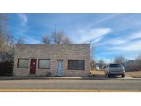 Stone building with red framed windows and doors at 3818 S Lowell Blvd, Sheridan, CO 80236