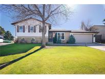 Charming two-story home with a well-maintained lawn and mature trees at 1922 S Ivory Way, Aurora, CO 80013