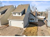 Charming townhome featuring a two-car garage and inviting front patio area at 10588 E Park Mtn, Littleton, CO 80127
