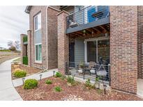 Charming townhome featuring a patio, second story balcony, and landscaped flower beds in front at 5187 S Fairplay St, Aurora, CO 80015