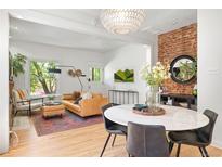 Inviting living room with hardwood floors, stylish decor, and exposed brick accent wall at 480 S Grant St, Denver, CO 80209