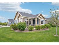 Charming single-story home with stone accents, lush landscaping, and a well-manicured lawn at 3595 E 124Th Pl, Thornton, CO 80241