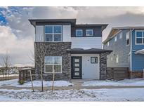 Two-story modern home with stone and siding exterior, welcoming front porch, and attached garage at 960 Superior Dr, Superior, CO 80027