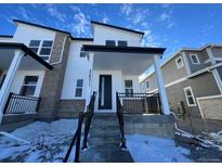 Two-story modern home with white siding, gray brick accents, and a covered front porch at 22831 E Stanford Ln # A, Aurora, CO 80015