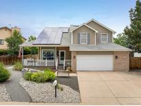 Charming two-story home with solar panels, covered porch, and meticulously landscaped front yard at 2777 W 106Th Cir, Denver, CO 80234