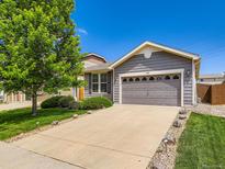 Charming single-Gathering home with a gray exterior and a two-car garage with a well-manicured lawn at 448 Bonanza Dr, Erie, CO 80516