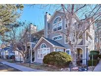 Inviting townhome with charming architectural details and mature landscaping, creating a warm and welcoming curb appeal at 6741 S Ivy Way # B4, Centennial, CO 80112