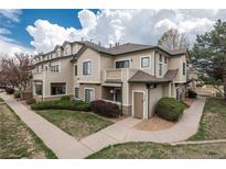 Inviting two-story townhome featuring neutral siding, a cozy balcony, and well-maintained landscaping at 8707 E Florida Ave # 510, Denver, CO 80247