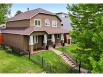 Stunning two-story home with a manicured front yard and inviting porch at 1366 S Vine St, Denver, CO 80210