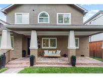 Charming front porch with stone flooring, white columns, and comfortable bench seating, offering a welcoming entrance at 1366 S Vine St, Denver, CO 80210