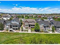Beautiful aerial view of a two-story home nestled in a neighborhood with mountain views in the distance at 4378 Fell Mist Way, Castle Rock, CO 80109