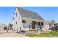 Charming house with white siding, a gray roof, and a well-maintained front yard, perfect for comfortable living at 235 S 8Th Ave, Brighton, CO 80601