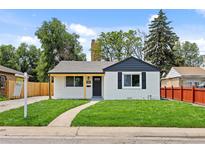Charming single-story home features a well-manicured lawn and inviting walkway at 851 S Eliot St, Denver, CO 80219