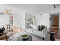 Open-concept living space with a dining area and neutral-toned furnishings at 700 N Washington St # 502, Denver, CO 80203