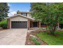 Charming two-story home with landscaped yard and a two-car garage on a sunny day at 8666 E Easter Ave, Centennial, CO 80112