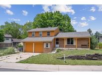 Charming two-story home features a brick facade, two-car garage, and a well-maintained front yard at 3625 E 128Th Pl, Thornton, CO 80241