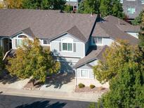 Charming townhome with manicured landscaping, inviting curb appeal, and an attached two-car garage at 1355 S Ulster St, Denver, CO 80231