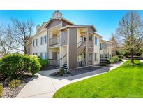 Two-story condo with a private entrance, lovely siding, and well-maintained landscaping at 8705 W Berry Ave # 204, Littleton, CO 80123