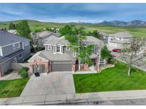 Charming two-story home with a well-manicured lawn and an attached two-car garage at 3207 Opal Ln, Superior, CO 80027