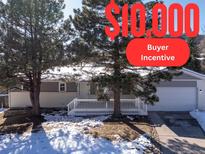 Ranch style home with gray siding, white trim, and a deck at 287 Johnson Dr, Castle Rock, CO 80104