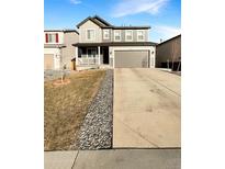 Charming two-story home with a two-car garage and well-maintained front yard at 228 N Edge Cliff St, Castle Rock, CO 80104