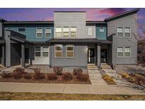 Modern townhome showcasing a colorful exterior with neat landscaping and welcoming front porch at 16251 E 47Th Pl, Denver, CO 80239