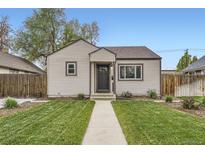 Charming single-story home with a well-manicured lawn and walkway leading to the front door at 4425 S Lincoln St, Englewood, CO 80113